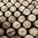 24106839-Detail-monochrome-view-of-stacked-wine-and-whisky-wooden-barrels-and-casks-Stock-Photo